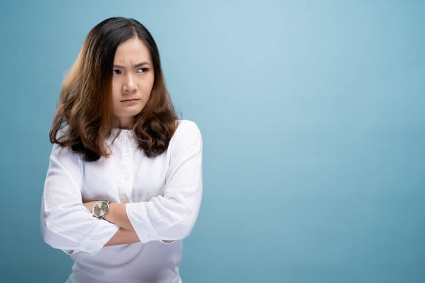 istock Angry woman standing isolated over blue background 1148211965