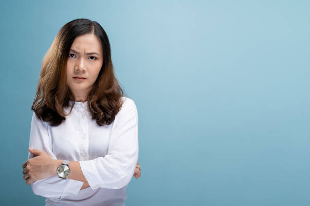 istock Angry woman standing isolated over blue background 1148211973