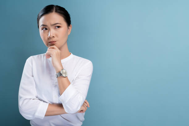 istock Woman feel confused isolated over blue background 1148212018