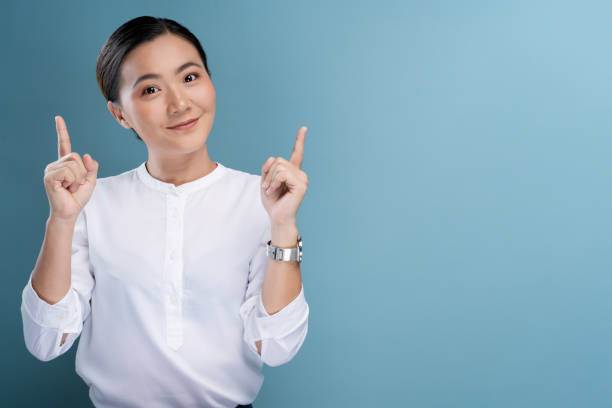 istock Happy woman thinking and standing isolated over blue background 1148212120