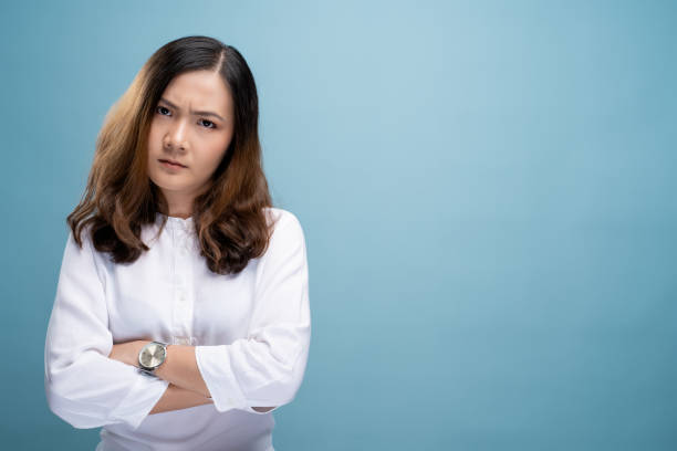 istock Angry woman standing isolated over blue background 1148212145