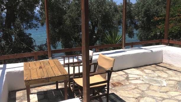 istock Two canvas chairs and wooden coffee table with a view on Mediterranean sea from balcony 1148216618