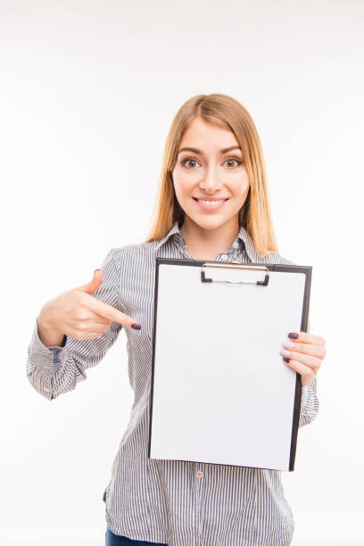 Successful pretty young woman pointing on file in a folder