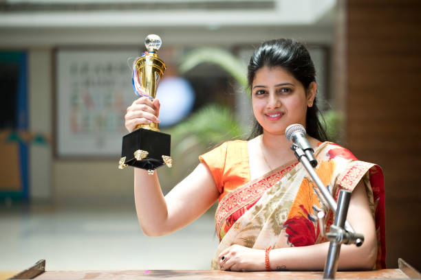 istock Teacher raising trophy and giving speech 1148219826