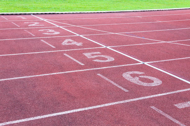 istock Numbers starting point on red running track,running track and green grass 1148221086