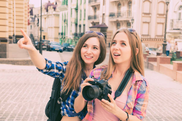 istock Two beautiful girlfriends with the camera to the tour 1148222440