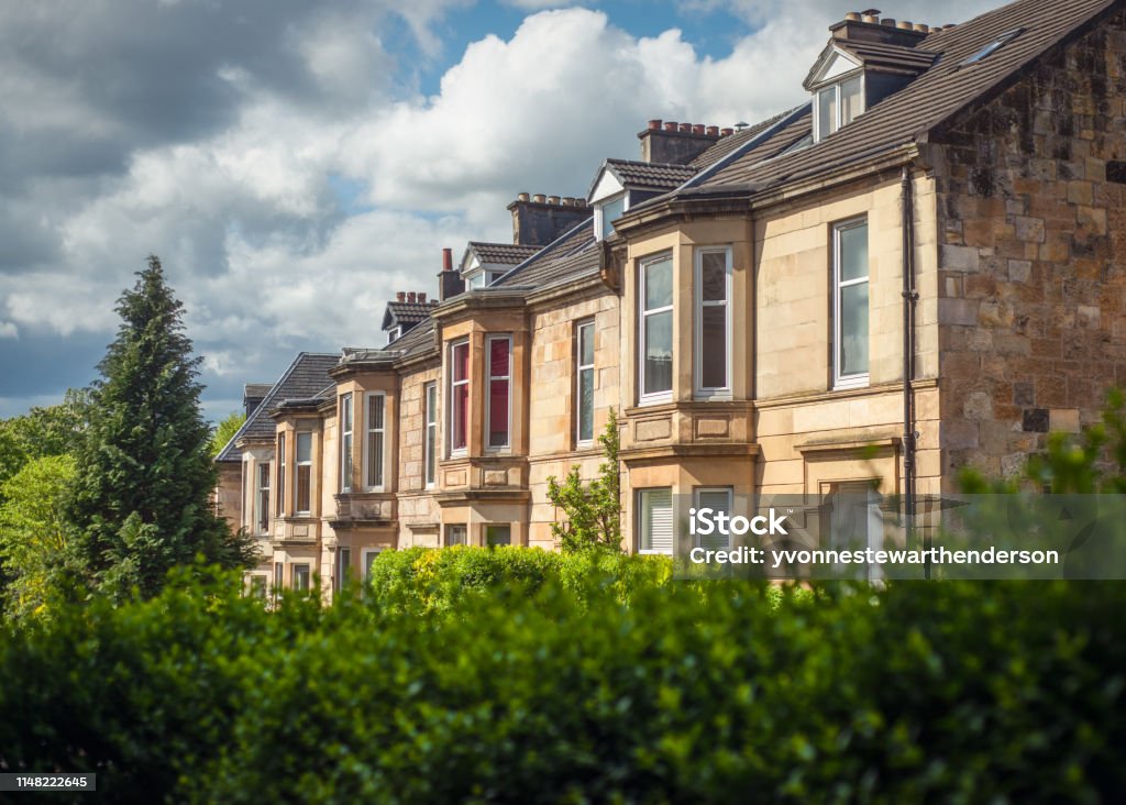 Sandstone Terrace Houses on a Leafy Street in the Southside of Glasgow Blonde Sandstone Terraced Homes on a Tree Lined Street in Glasgow Scotland UK Stock Photo