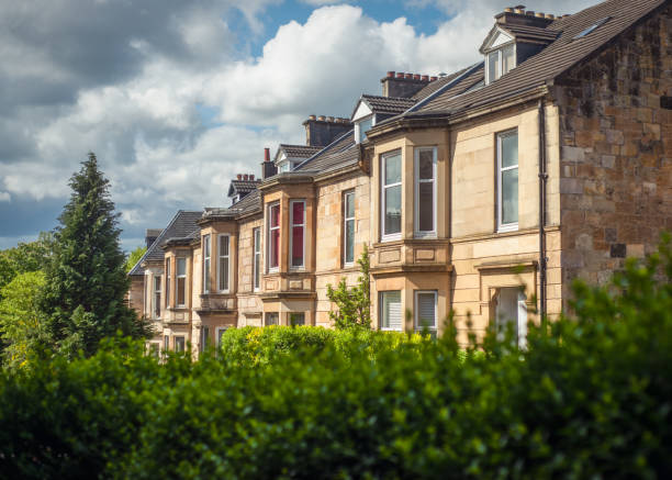 Sandstone Terrace Houses on a Leafy Street in the Southside of Glasgow Blonde Sandstone Terraced Homes on a Tree Lined Street in Glasgow Scotland sandstone photos stock pictures, royalty-free photos & images