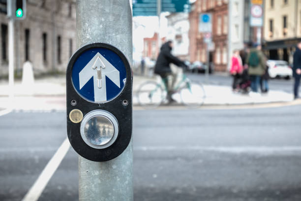 button to activate pedestrian crossing on the road on a pedestrian crossing in the city center on a winter day