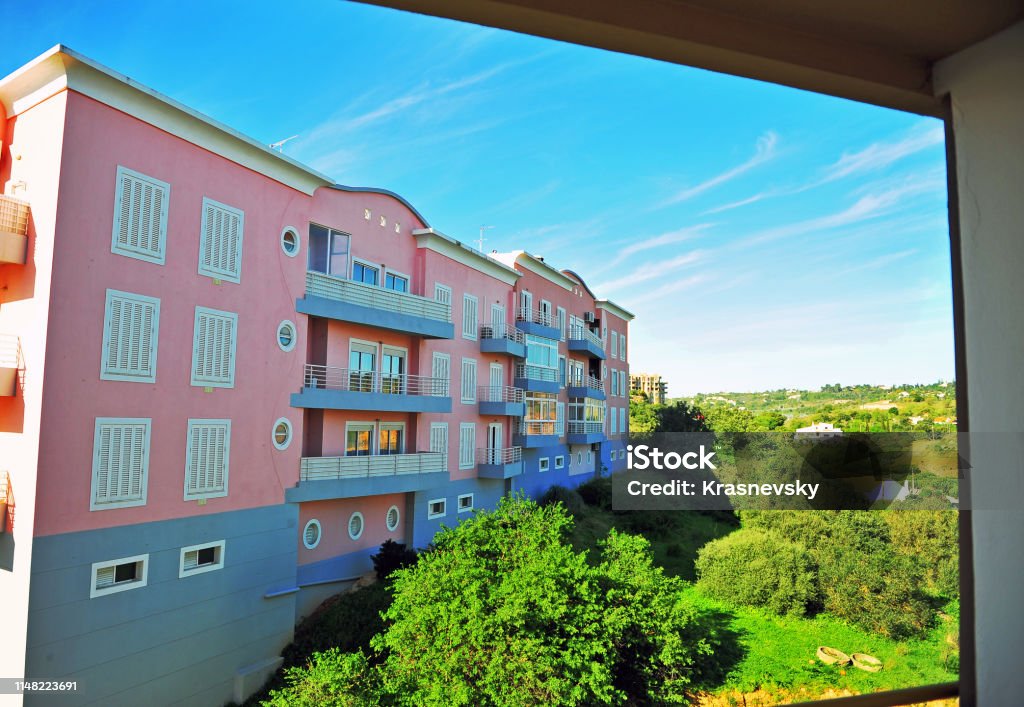 View of pink modern house throug the window frame Balcony Stock Photo