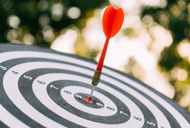 istock Target dart and arrow with abstract nature bokeh blur background 1148223942