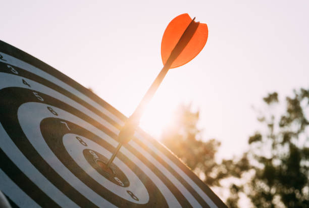 Target dart and arrow with abstract nature bokeh blur background
