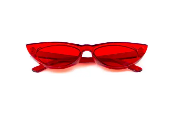 Red cat eye sunglasses with thick frame at isolated white background, folded front view
