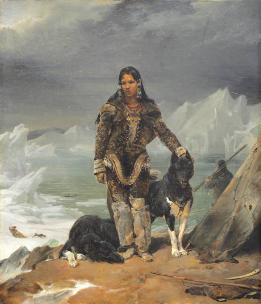 istock Eskimo woman with dogs at the sea, during hunting 1148226441