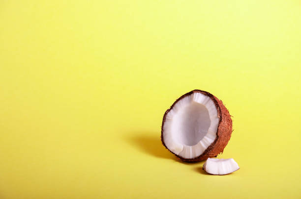 istock Half Coconut on Yellow Background. Exotic Food. Summer Tropical Concept. Copy Space For Your Text 1148227112