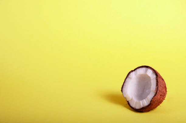 istock Half Coconut on Yellow Background. Exotic Food. Summer Tropical Concept. Copy Space For Your Text 1148227114