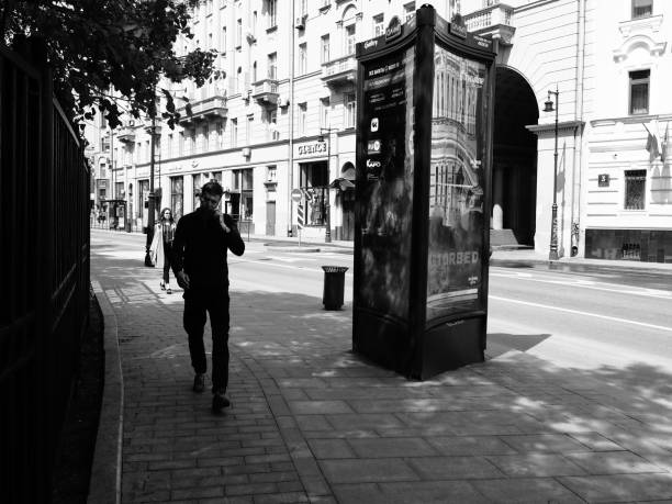 Moscow, Russia - May 10, 2019: a young man is walking on the street and talking by phone