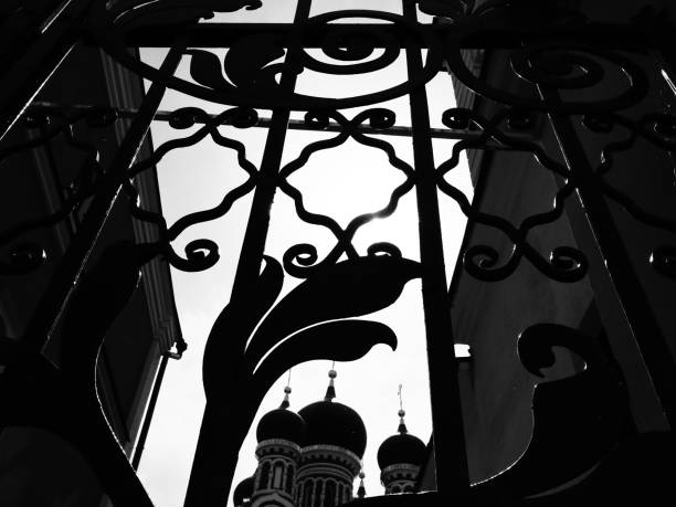 Moscow, Russia - May 10, 2019: top of orthodox church viewed through the forged gate in Sadovnicheskaya street
