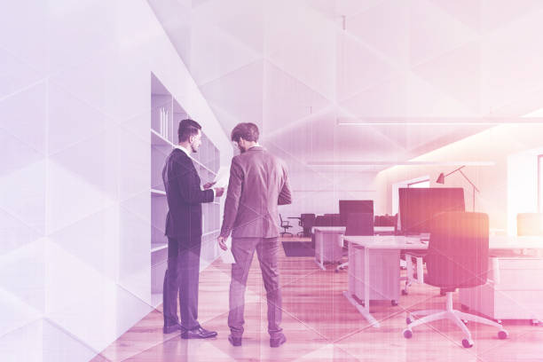 istock Men in open space office with meeting room 1148231302