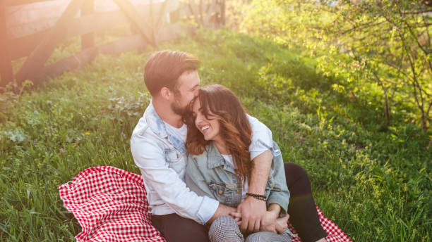 istock Loving couple cuddling on green meadow 1148231397