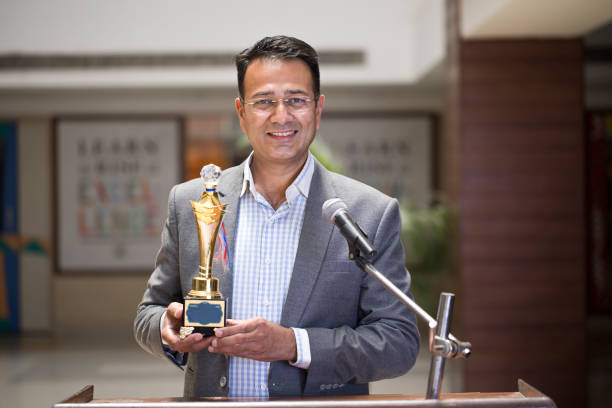istock Teacher raising trophy and giving speech 1148232025