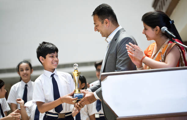 istock Teachers applauding for student at awards ceremony 1148232031