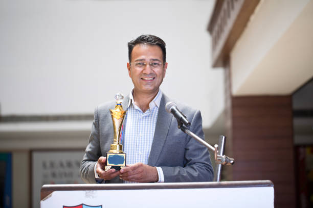 istock Teacher raising trophy and giving speech 1148232039