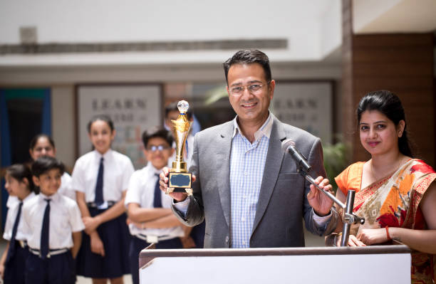 istock Teachers applauding for student at awards ceremony 1148232052