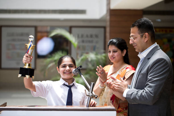 istock Teachers applauding for student at awards ceremony 1148232055