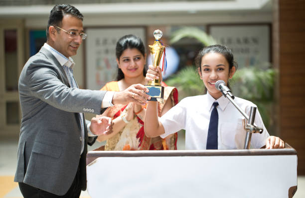 istock Teachers applauding for student at awards ceremony 1148232057