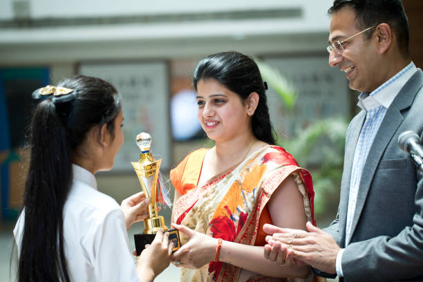 istock Teachers applauding for student at awards ceremony 1148232066