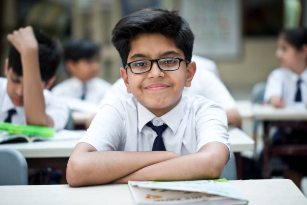 istock Portrait of schoolboy sitting at class 1148232210