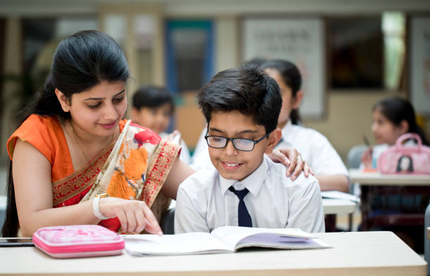 istock Teacher helping schoolboy with writing 1148232244