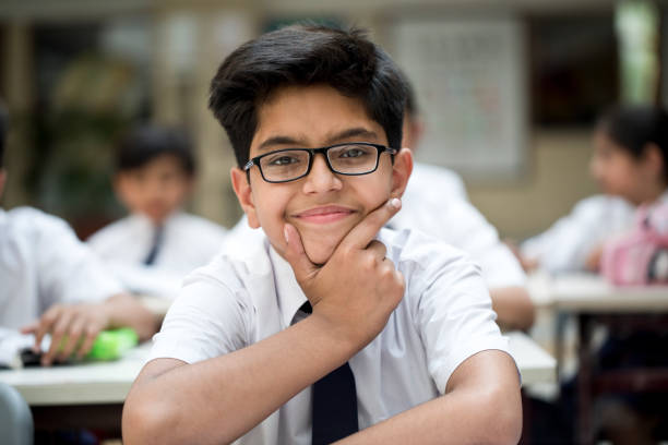 istock Portrait of schoolboy sitting at class 1148232275