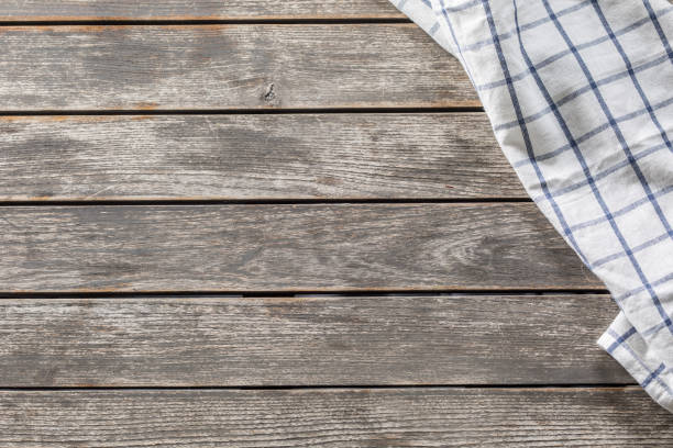 istock Blue white checketed tablecloth on wooden kitchen table - top of view 1148232778