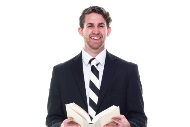 istock Good looking young businessman wearing black suit - holding book 1148234877