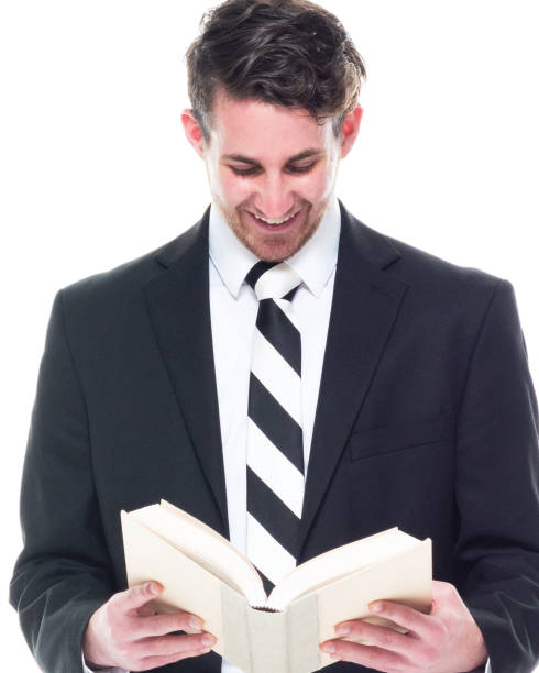 istock Good looking young businessman wearing black suit - holding book 1148234878