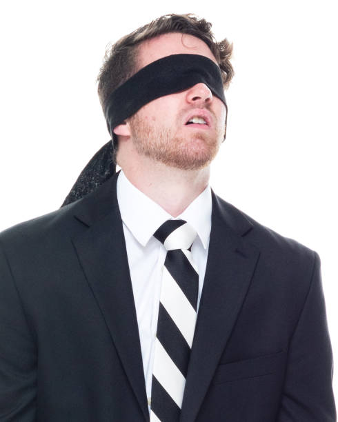 istock Handsome businessman wearing a black suit - is wearing a blindfold 1148234980