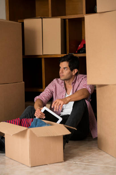 istock Man opening boxes of his house change 1148235141