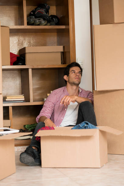 istock Man opening boxes of his house change 1148235366