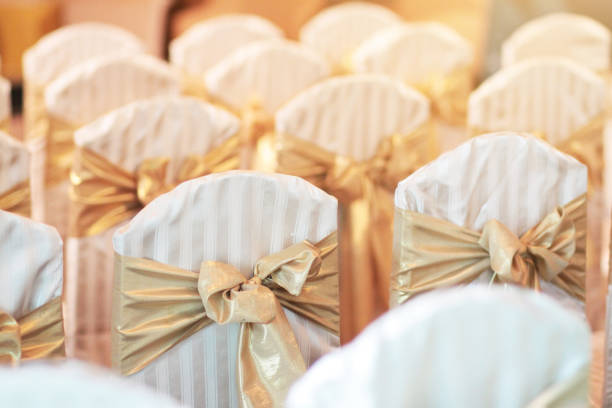 istock Beautiful chairs decoration with ribbon in wedding event hall, selective focus. 1148235406