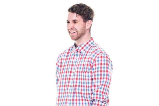istock Attractive young man wearing a checked shirt and jeans - using a laptop 1148235417