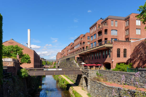 istock Pedestrian Path along a Canal between Old Renovated Brick Buildings in Summer, Washington DC 1148236379