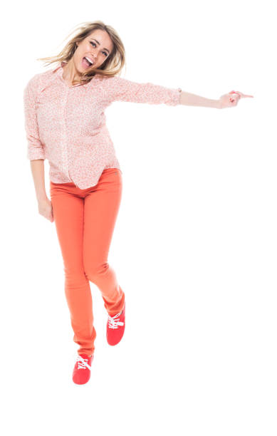 istock Beautiful female jumping - pointing to the side 1148237139