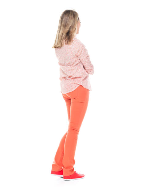 Good looking white female standing on white background - is thinking