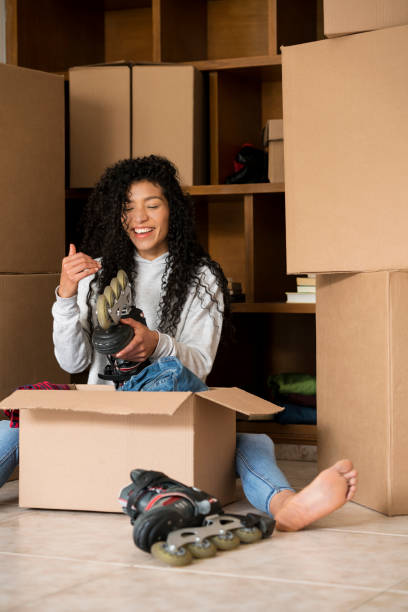 istock Woman opening boxes in her house change 1148237162
