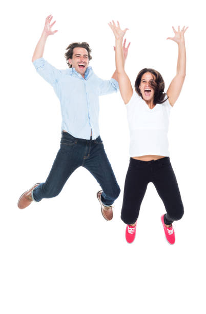 istock Attractive couple jumping for joy 1148238003