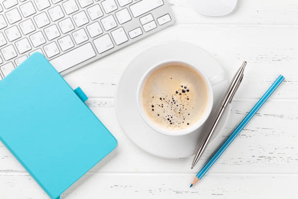 istock Office desk with notepad, coffee cup and supplies 1148239265