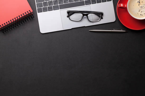 istock Office workplace table with coffee, supplies and computer 1148239405