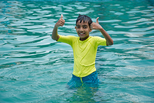Indian boy enjoy summer vacation  at water park